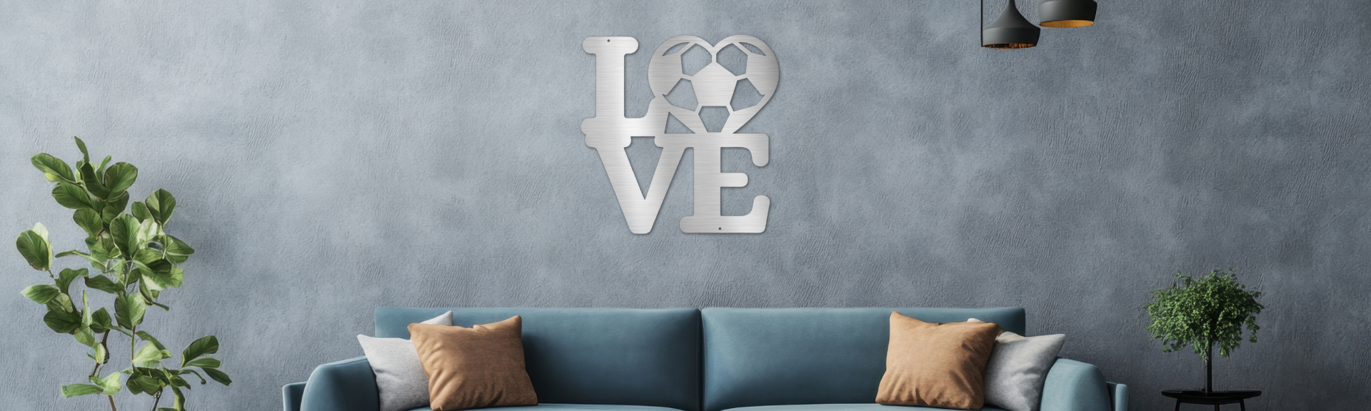 Decorative wall art spelling 'LOVE'  with a soccer ball heart above a blue sofa in a living room setting.